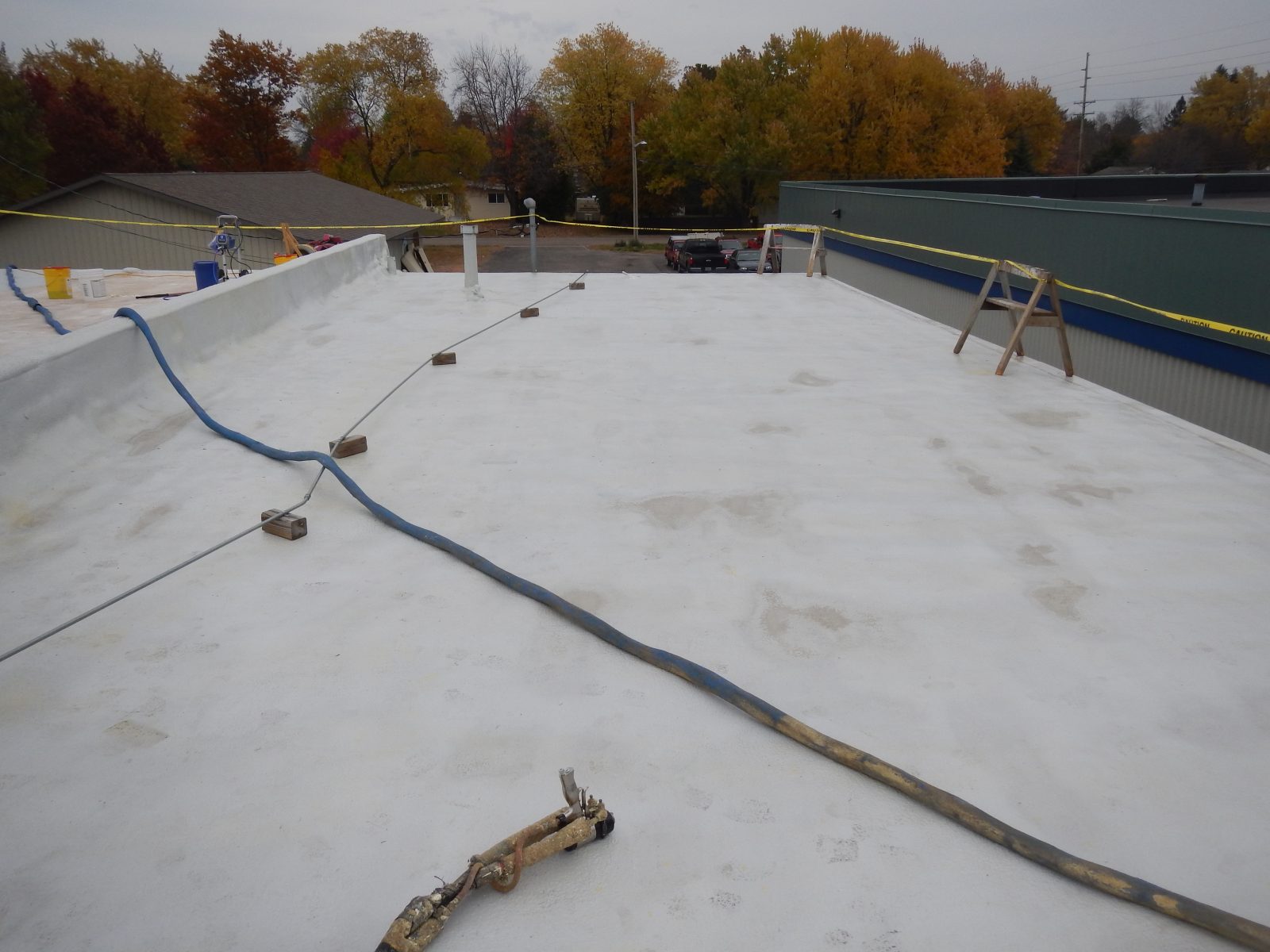 Corrugated structural metal roof deck with polyurea waterproofing membrane